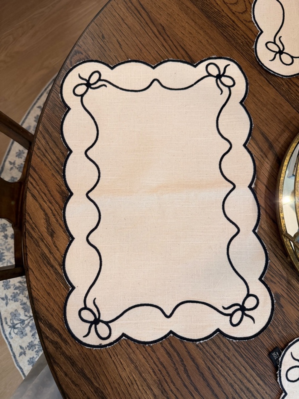 Rachel Zoe Cream Placemat with Black Scallop and Bow Trim. 4 placemats